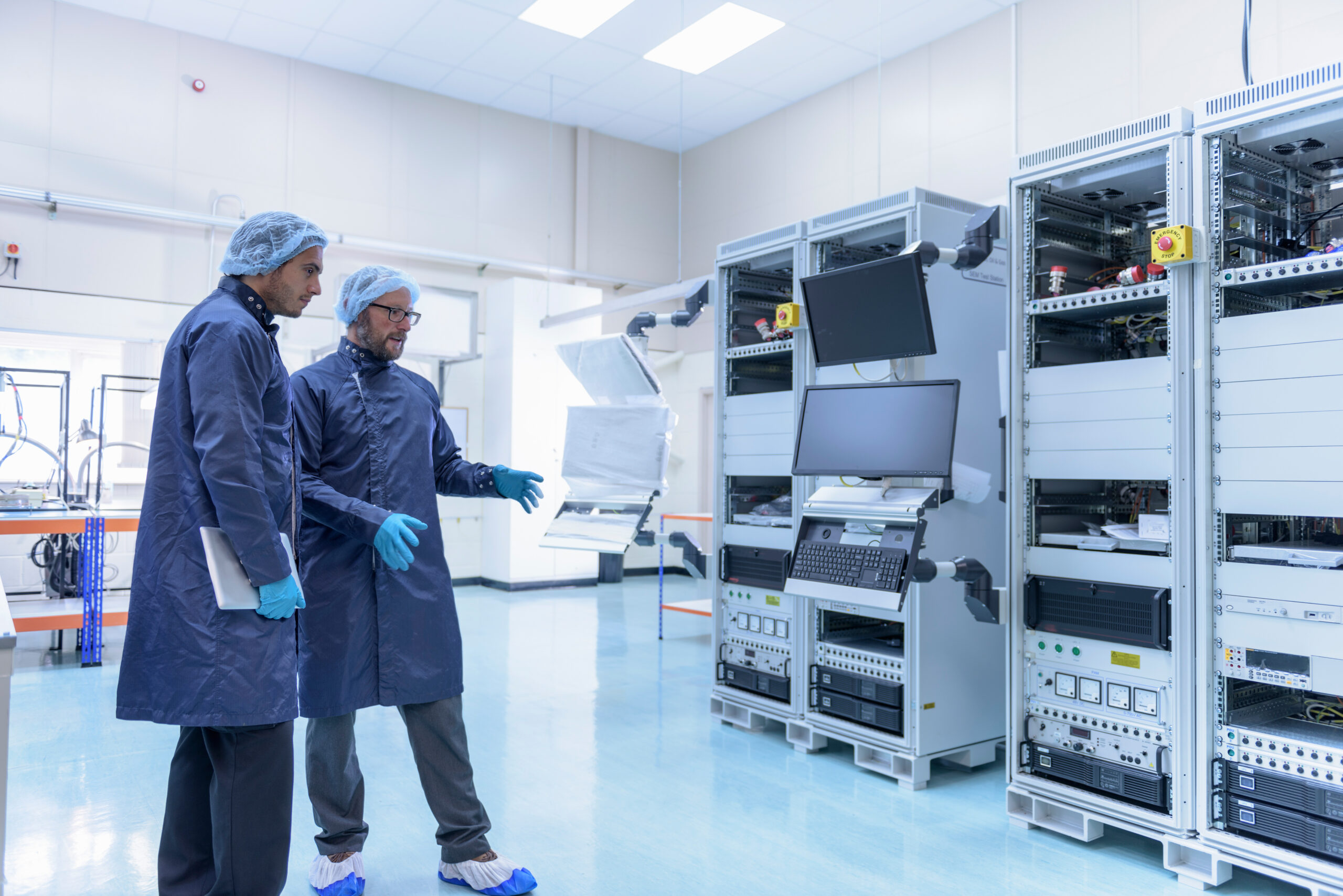 Workers in clean room in electronics factory